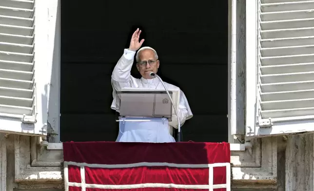 Pope Leo XIV appears at his studio's window to bless the faithful gathered in St. Peter's Square at the Vatican for the Angelus prayer, Sunday, July 6, 2025. (AP Photo/Andrew Medichini)