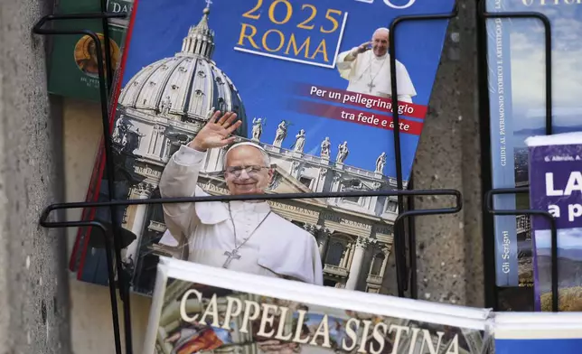 A guide book with an image of Pope Leo XIV on its cover is on display outside a souvenir shop in the town of Castel Gandolfo, a historic summer retreat for popes about 30 kilometers southeast of Rome, where Pope Leo XIV will be spending a short period of rest, is seen Wednesday, July 2, 2025. (AP Photo/Andrew Medichini)