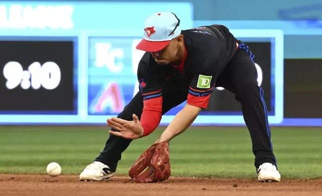 Toronto Blue Jays second baseman Andres Gimenez (0) fields a ground ball off the bat of Los Angeles Angels' Nolan Schanuel in sixth inning of a baseball game in Toronto, Friday, July 4, 2025. (Jon Blacker/The Canadian Press via AP)