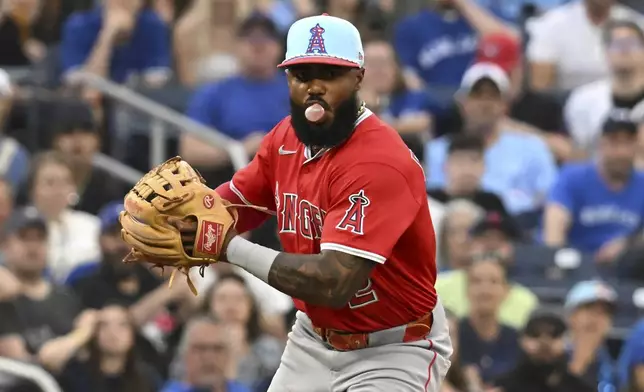 Los Angeles Angels third baseman Luis Rengifo throws to first base to force out Toronto Blue Jays' Davis Schneider in fifth-inning baseball game action in Toronto, Friday, July 4, 2025. (Jon Blacker/The Canadian Press via AP)