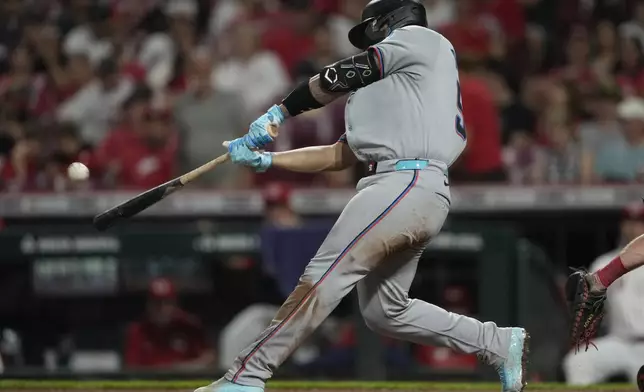 Miami Marlins' Agustín Ramírez hits a solo home run during the seventh inning of a baseball game against the Cincinnati Reds in Cincinnati, Monday, July 7, 2025. (AP Photo/Carolyn Kaster)
