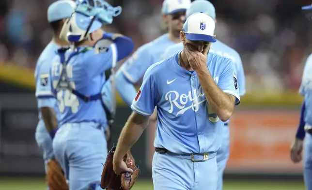 Kansas City Royals starting pitcher Michael Wacha walks off the field after being replaced during the fifth inning of a baseball game against the Arizona Diamondbacks Saturday, July 5, 2025, in Phoenix. (AP Photo/Ross D. Franklin)