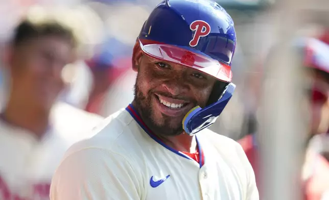 Philadelphia Phillies' Edmundo Sosa smiles in the dugout after hitting a solo home run off Cincinnati Reds pitcher Nick Lodolo during the fifth inning of a baseball game, Saturday, July 5, 2025, in Philadelphia. (AP Photo/Derik Hamilton)