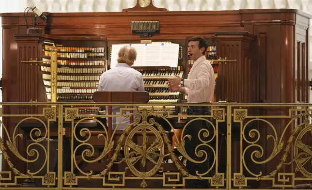 Anthony Roth Costanzo, right, of Opera Philadelphia, and Peter Richard Conte, Wanamaker grand court organist, perform at the storied Wanamaker Building, July 24, 2025, in Philadelphia. (AP Photo/Matt Slocum)