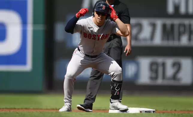 Boston Red Sox's Rob Refsnyder gestures at second base after hitting a a double during the first inning of a baseball game against the Washington Nationals, Saturday, July 5, 2025, in Washington. (AP Photo/Nick Wass)