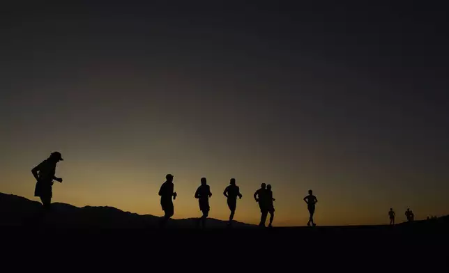 Danny Westergaard, leading the center group of runners, competes during the Badwater 135 Ultramarathon, Monday, July 7, 2025, near Badwater Basin in Death Valley National Park, Calif. (AP Photo/John Locher)