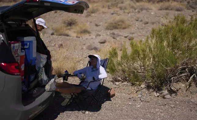 Danny Westergaard takes a break while competing in the Badwater 135 Ultramarathon, Tuesday, July 8, 2025, in Death Valley National Park, Calif. (AP Photo/John Locher)