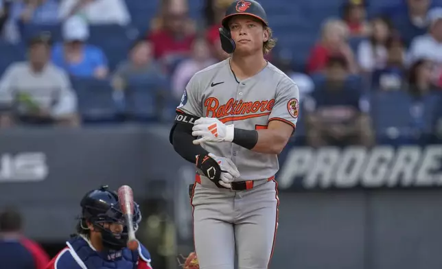 Baltimore Orioles' Jackson Holliday tosses his bat as he is walked in the third inning of a baseball game against the Cleveland Guardians in Cleveland, Tuesday, July 22, 2025. (AP Photo/Sue Ogrocki)