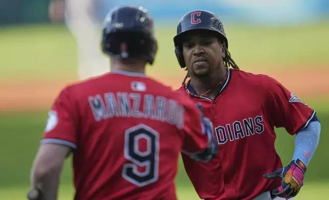 Cleveland Guardians' Jose Ramirez, right, is congratulated by Kyle Manzardo (9) after his home run in the first inning of a baseball game against the Baltimore Orioles in Cleveland, Tuesday, July 22, 2025. (AP Photo/Sue Ogrocki)