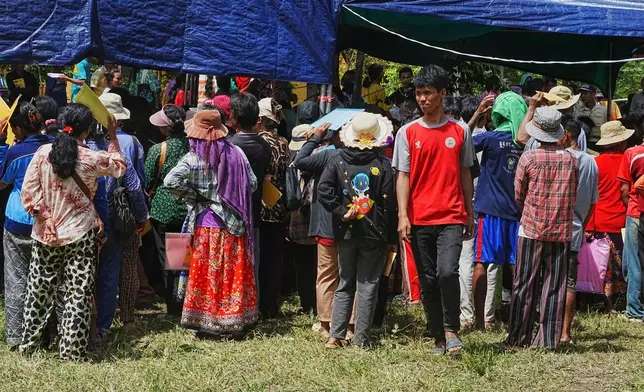 Cambodians who fled their villages line up to register for receiving donations as they take refuge in Wat Tham Kambar in Oddar Meanchey province, Cambodia, Friday, July 25, 2025, as Thai and Cambodian soldiers have clashed along the border between their countries in a major escalation. (AP Photo/Heng Sinith)