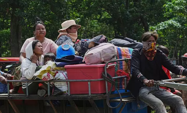 Cambodians sit on a tractor as they take refuge in Wat Tham Kambar in Oddar Meanchey province, Cambodia, Friday, July 25, 2025, as Thai and Cambodian soldiers have clashed along the border between their countries in a major escalation. (AP Photo/Heng Sinith)