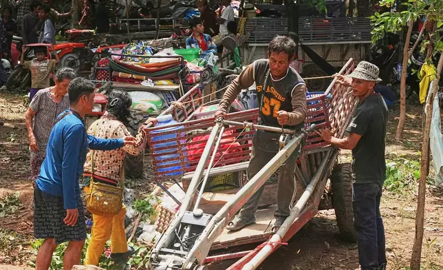 Cambodians who fled their villages park their tractors as they take refuge in Wat Tham Kambar in Oddar Meanchey province, Cambodia, Friday, July 25, 2025, as Thai and Cambodian soldiers have clashed along the border between their countries in a major escalation. (AP Photo/Heng Sinith)