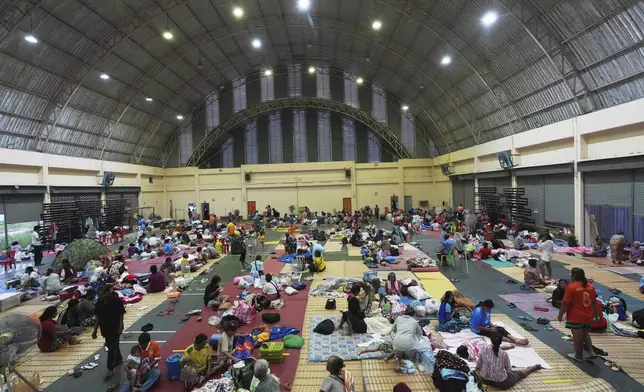Thai residents who fled homes following clashes between Thai and Cambodian soldiers rest at an evacuation center in Surin province, Thailand, Friday, July 25, 2025. (AP Photo/Sakchai Lalit)
