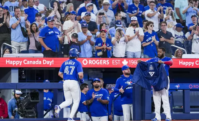 Toronto Blue Jays' Addison Barger (47) celebrates after his solo home run with Vladimir Guerrero Jr., front right, during fifth-inning baseball game action against the New York Yankees in Toronto, Thursday, July 3, 2025. (Thomas Skrlj/The Canadian Press via AP)