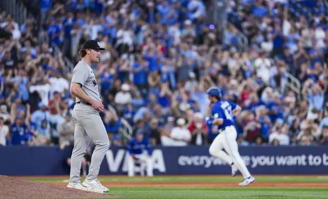 New York Yankees pitcher Clayton Beeter, left, reacts after giving up a home run to Toronto Blue Jays' Addison Barger (47) during fifth-inning baseball game action in Toronto, Thursday, July 3, 2025. (Thomas Skrlj/The Canadian Press via AP)