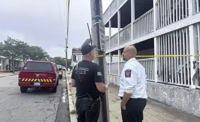 Falls River Fire Chief Jeffrey Bacon, right, speaks with another official after a fire the Gabriel House assisted living facility in Falls River, Mass., Monday, July 14, 2025. (AP Photo/Michael Casey)