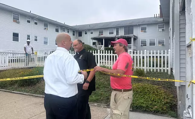 Dennis Etzkorn, owner of Gabriel House, right, visits the site in the aftermath of a fire alongside Fall River Fire Chief Jeffrey Bacon, left, Monday, July 14 in Fall River, Mass, (Michael Casey)