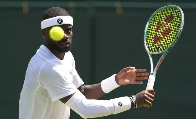 Frances Tiafoe of the U.S. returns the ball to Elmer Moller of Denmark during their first round men's single match at the Wimbledon Tennis Championships in London, Monday, June 30, 2025. (AP Photo/Kirsty Wigglesworth)