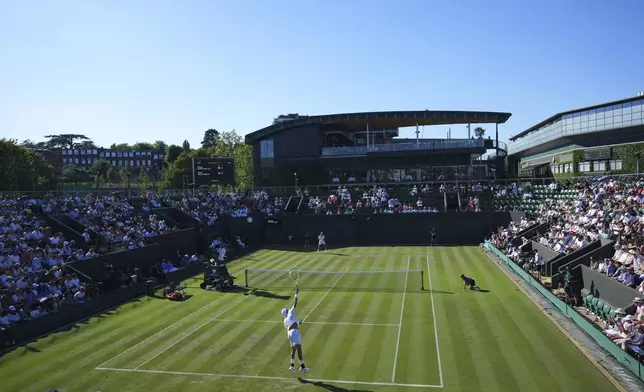 Matteo Berrettini of Italy serves to Kamil Majchrzak of Poland in their first round men's singles match at the Wimbledon Tennis Championships in London, Monday, June 30, 2025. (AP Photo/Joanna Chan)