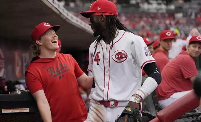 Cincinnati Reds pitcher Andrew Abbott, left, and shortstop Elly De La Cruz celebrate in the dugout as it was announced that Abbott will join De La Cruz as the Reds' representatives for the 2025 Major League Baseball All-Star Game, during the fourth inning of a baseball game against the Miami Marlins in Cincinnati, Tuesday, July 8, 2025. (AP Photo/Carolyn Kaster)