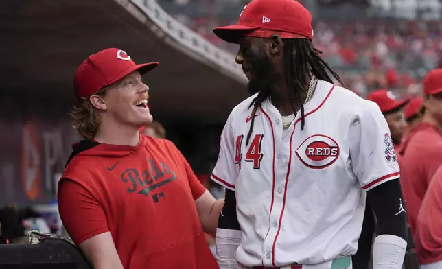 Cincinnati Reds pitcher Andrew Abbott, left, and shortstop Elly De La Cruz celebrate in the dugout as it was announced that Abbott will join De La Cruz as the Reds' representatives for the 2025 Major League Baseball All-Star Game, during the fourth inning of a baseball game against the Miami Marlins in Cincinnati, Tuesday, July 8, 2025. (AP Photo/Carolyn Kaster)