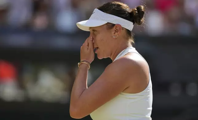 Amanda Anisimova of the U.S. reacts as she plays Poland's Iga Swiatek during the women's singles final at the Wimbledon Tennis Championships in London, Saturday, July 12, 2025. (AP Photo/Kin Cheung)
