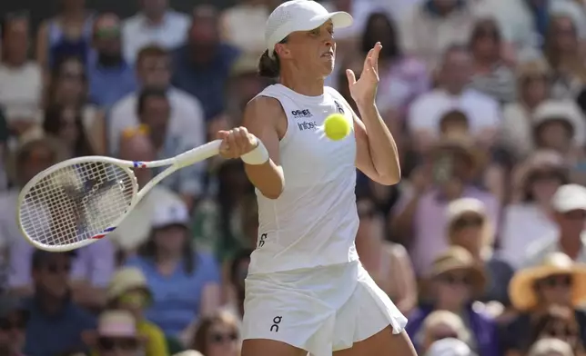 Poland's Iga Swiatek returns to Amanda Anisimova of the U.S. during the women's singles final at the Wimbledon Tennis Championships in London, Saturday, July 12, 2025. (AP Photo/Kin Cheung)