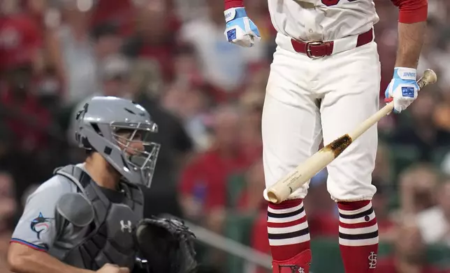 St. Louis Cardinals' Brendan Donovan (33) leaps in the air after being called out on strikes as Miami Marlins catcher Agustin Ramirez, left, looks on during the fifth inning of a baseball game Wednesday, July 30, 2025, in St. Louis. (AP Photo/Jeff Roberson)