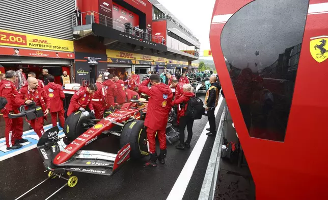 Crew work on the car of Ferrari driver Lewis Hamilton of Britain prior to the start of the Formula One Grand Prix at the Spa-Francorchamps racetrack in Spa, Belgium, Sunday, July 27, 2025. (Yves Herman, Pool Photo via AP)