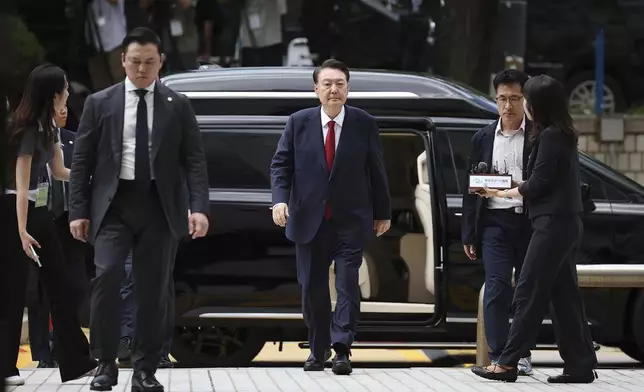 Former South Korean President Yoon Suk Yeol, centerm arrives at a court to attend a hearing to review his arrest warrant requested by special prosecutors in Seoul, South Korea Wednesday, July 9, 2025. (Kim Hong-Ji/Pool Photo via AP)