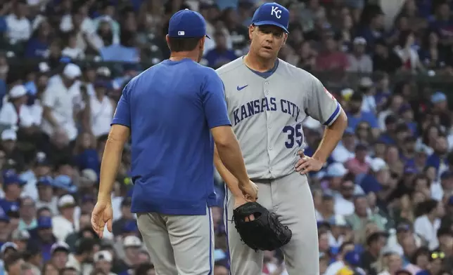 Kansas City Royals starting pitcher Rich Hill, right, talks with pitching coach Brian Sweeney during the second inning of a baseball game against the Chicago Cubs in Chicago, Tuesday, July 22, 2025. (AP Photo/Nam Y. Huh)