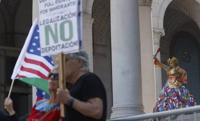 Demonstrators take part in a protest against President Donald Trump's policies on Friday, July 4, 2025 in Los Angeles. (AP Photo/Jill Connelly)