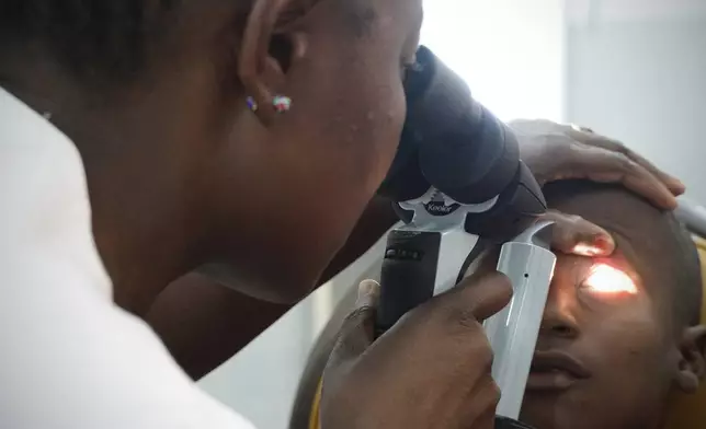 Dr. Claudette Yaméogo, Burkina Faso's only ophthalmologist specializing in treating children, checks Isaka Diallo who has lost vision in his left eye at the Sanou Sourou University Hospital in the city of Bobo-Dioulasso, Burkina Faso, Thursday, June 5, 2025. (AP Photo/Elia Borras)