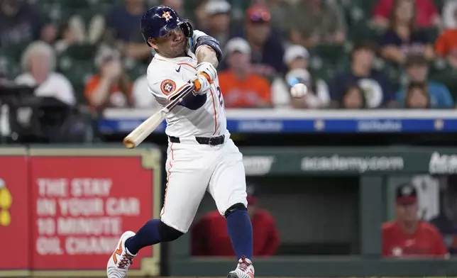 Houston Astros' Jose Altuve hits a three-run home run against the Washington Nationals during the second inning of a baseball game Wednesday, July 30, 2025, in Houston. (AP Photo/David J. Phillip)