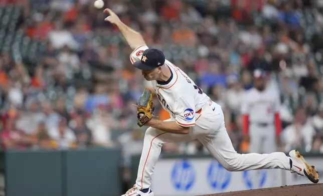Houston Astros starting pitcher Ryan Gusto throws against the Washington Nationals during the first inning of a baseball game Wednesday, July 30, 2025, in Houston. (AP Photo/David J. Phillip)