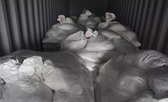 Gravel-filled bags with mercury hidden inside sit inside a seized container in Lima, Peru, Wednesday, July 16, 2025. (AP Photo/Guadalupe Pardo)