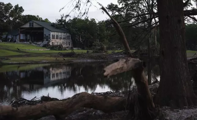 FILE - A building at Camp Mystic is reflected in water after a flash flood swept through the area July 7, 2025, in Hunt, Texas. (AP Photo/Eli Hartman, File)