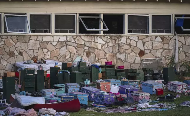 FILE - The belongings of campers sit outside one of Camp Mystic's cabins near the Guadalupe River in Hunt, Texas, on Monday, July 7, 2025, after a deadly flash flood swept through the area. (AP Photo/Eli Hartman, File)