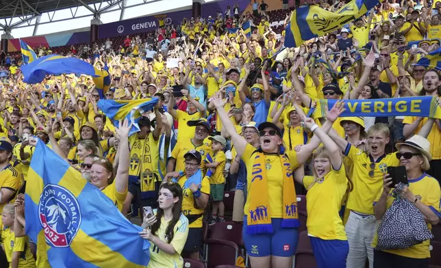 Sweden's fans celebrate after the Euro 2025, group C, soccer match between Denmark and Sweden at Stade de Geneve in Geneva, Switzerland, Friday, July 4, 2025. (AP Photo/Alessandra Tarantino)