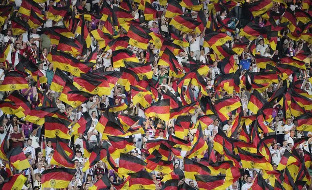 German supporters wave flags on the stands during the Euro 2025, group C, soccer match between Germany and Poland at Arena St. Gallen in St. Gallen, Switzerland, Friday, July 4, 2025. (AP Photo/Martin Meissner)