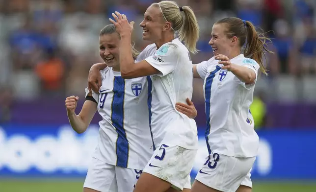 Finland 's Katariina Kosola, left, celebrates with Emma Koivisto, center, after scoring her side's first goal during the Euro 2025, group A, soccer match between Iceland and Finland at Arena Thun in Thun, Switzerland, Wednesday, July 2, 2025. (AP Photo/Alessandra Tarantino)