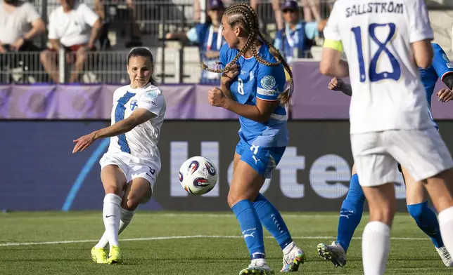 Finland 's Katariina Kosola, left, scores during the Euro 2025, group A, soccer match between Iceland and Finland at Arena Thun in Thun, Switzerland, Wednesday, July 2, 2025. (Anthony Anex/Keystone via AP)