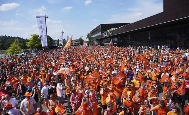 Netherlands supporters head to the stadium for the Euro 2025, group D, soccer match between Wales and the Netherlands at Allmend Stadion Luzern in Lucerne, Switzerland, Saturday, July 5, 2025. (AP Photo/Alessandra Tarantino)
