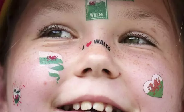 A young Wales supporter waits for the Euro 2025, group D, soccer match between Wales and the Netherlands at Allmend Stadion Luzern in Lucerne, Switzerland, Saturday, July 5, 2025. (AP Photo/Alessandra Tarantino)