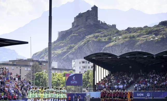 Players and fans hold a minute of silence for Portuguese soccer player Diogo Jota who died in a car accident in Spain, before the Euro 2025, group B, soccer match between Belgium and Italy at Stade de Tourbillon in Sion, Switzerland, Thursday, July 3, 2025. (Laurent Gillieron/Keystone via AP)