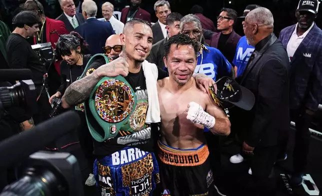 Mario Barrios, left, and Manny Pacquiao one for a photo after fighting to a majority draw in a welterweight title boxing match Saturday, July 19, 2025, in Las Vegas. (AP Photo/John Locher)