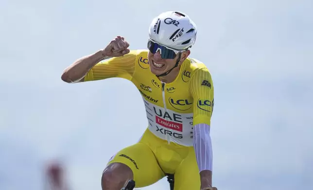 Slovenia's Tadej Pogacar, wearing the overall leader's yellow jersey, celebrates winning the thirteenth stage of the Tour de France cycling race, an individual time-trial over 10.5 kilometers (6.5 miles) in the Pyrenees mountains with start in Loudenvielle and finish in Peyragudes, France, Friday, July 18, 2025. (AP Photo/Thibault Camus)