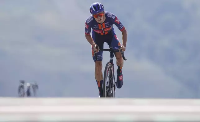 Britain's Oscar Onley climbs during the thirteenth stage of the Tour de France cycling race, an individual time-trial over 10.5 kilometers (6.5 miles) in the Pyrenees mountains with start in Loudenvielle and finish in Peyragudes, France, Friday, July 18, 2025. (AP Photo/Thibault Camus)