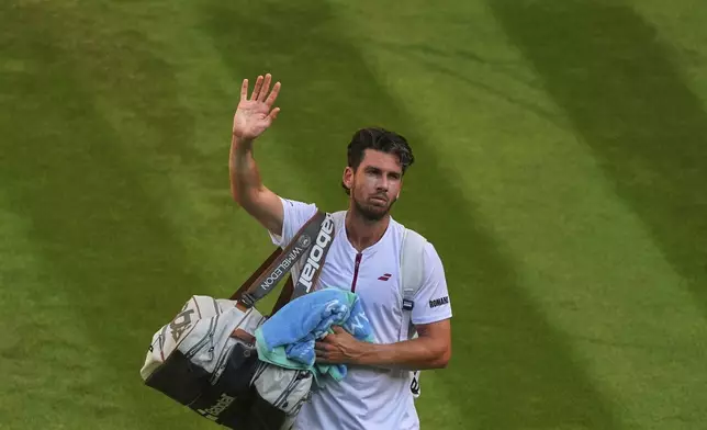 Britain's Cameron Norrie waves as he leaves the court after losing to Spain's Carlos Alcaraz during a quarterfinal men's singles match at the Wimbledon Tennis Championships in London, Tuesday, July 8, 2025. (AP Photo/Joanna Chan)