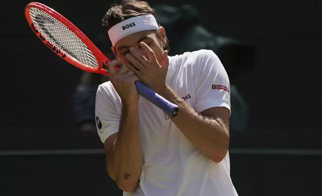 Taylor Fritz of the U.S. reacts during the men's singles quarter final match against Karen Khachanov of Russia at the Wimbledon Tennis Championships in London, Tuesday, July 8, 2025.(AP Photo/Kin Cheung)